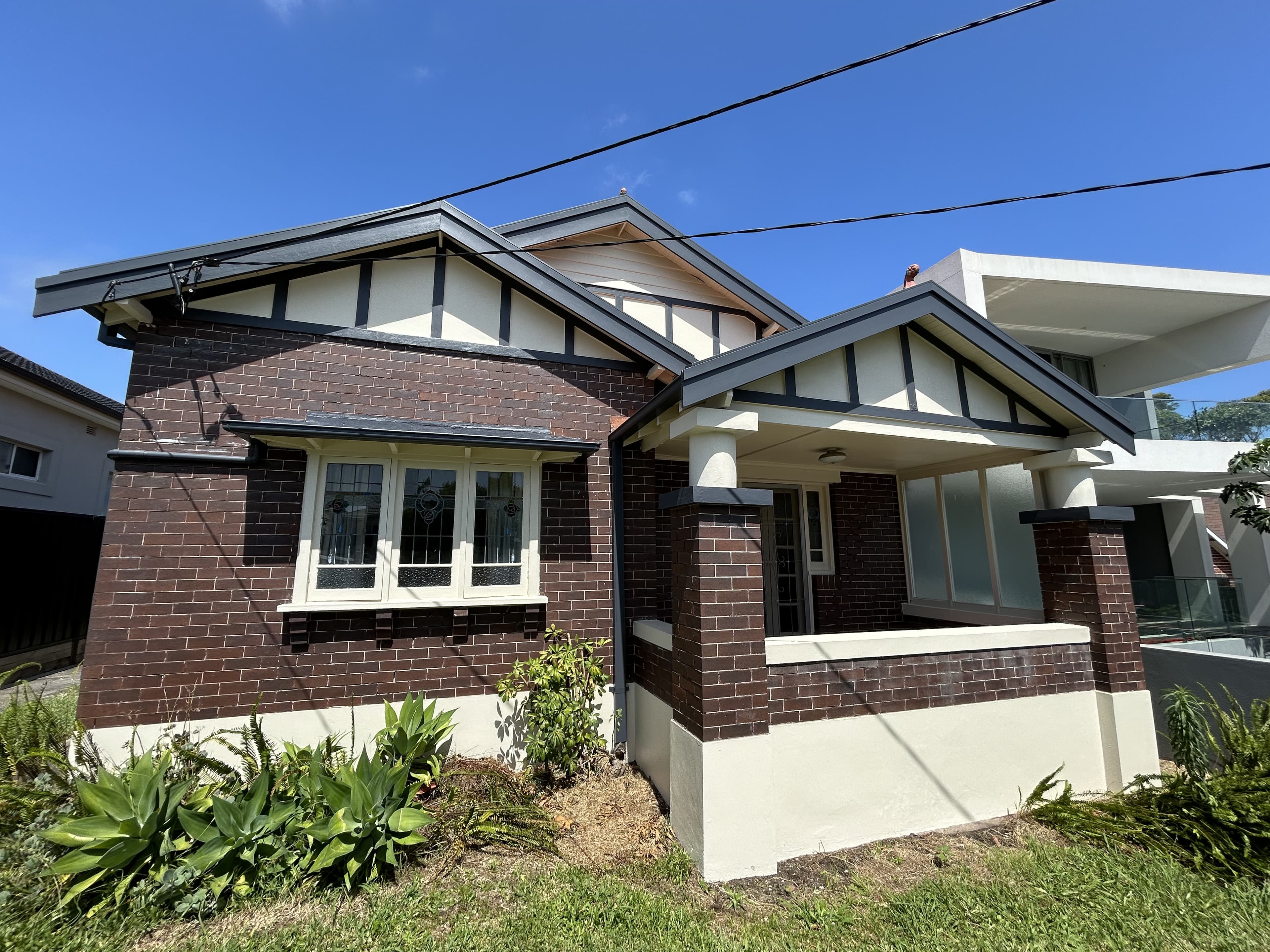 Front of an Earlwood house exterior after repainting with fresh trim and facade finishes